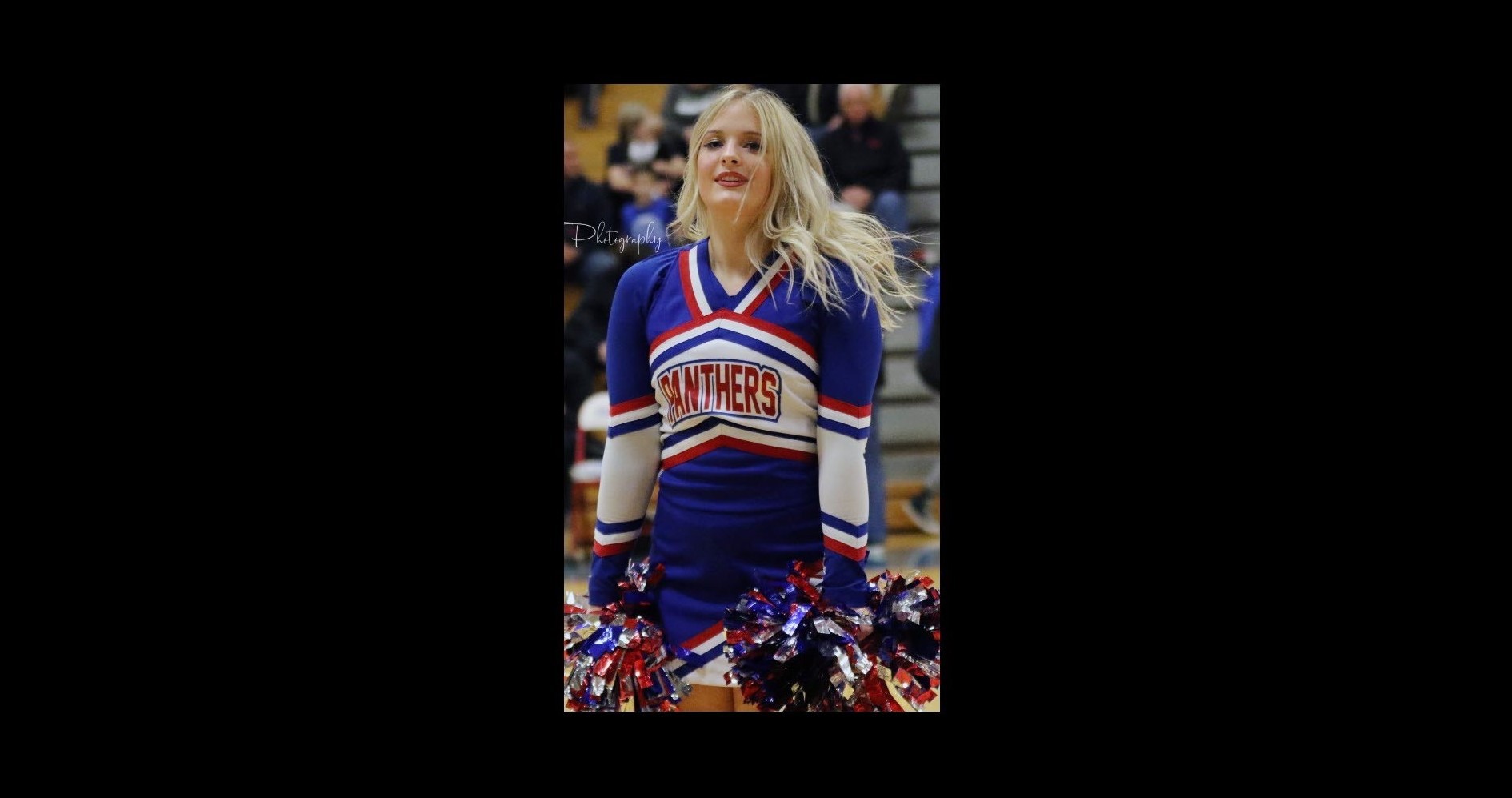 Cheerleader with red white and blue panthers uniform on